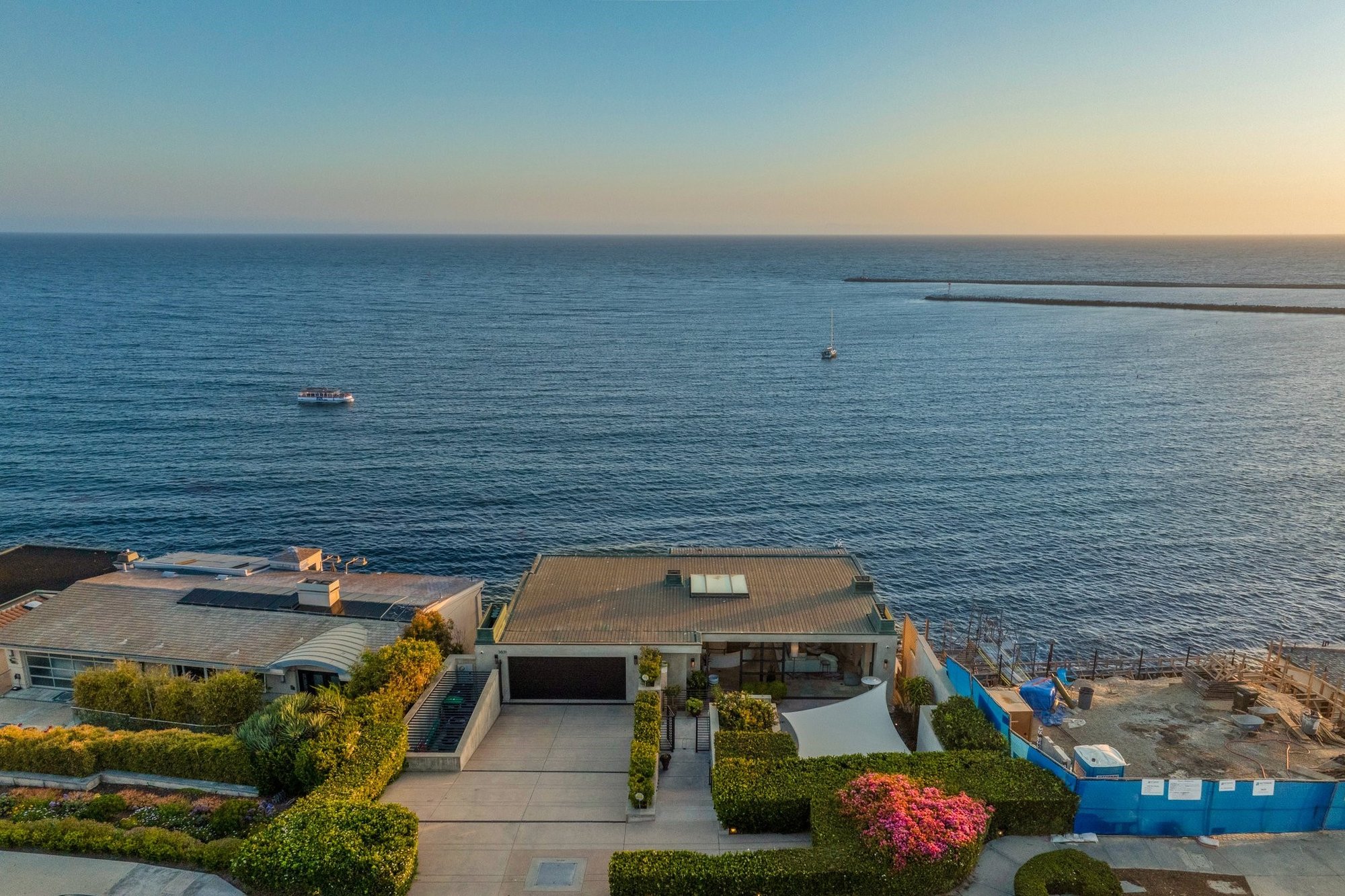 Ocean Boulevard bluff-front homes overlooking Corona del Mar State Beach and the Newport Harbor jetty